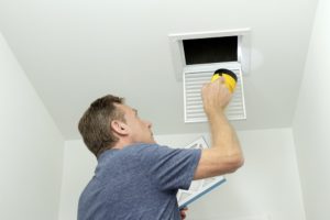 hvac technician closing vents to unused rooms